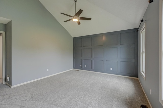 880 Norell Ave N, West Lakeland Twp, MN 55082 - empty room featuring high vaulted ceiling, ceiling fan, carpet floors, a decorative wall, and baseboards