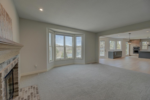 880 Norell Ave N, West Lakeland Twp, MN 55082 - unfurnished living room featuring a fireplace, light carpet, baseboards, and recessed lighting