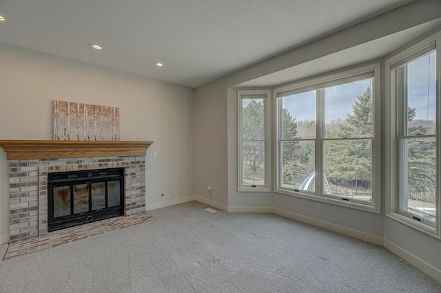 880 Norell Ave N, West Lakeland Twp, MN 55082 - unfurnished living room with baseboards, recessed lighting, carpet flooring, a fireplace, and a textured ceiling