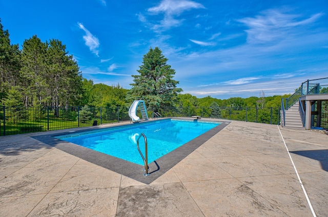 880 Norell Ave N, West Lakeland Twp, MN 55082 - view of pool featuring a water slide, stairs, a patio, and a diving board