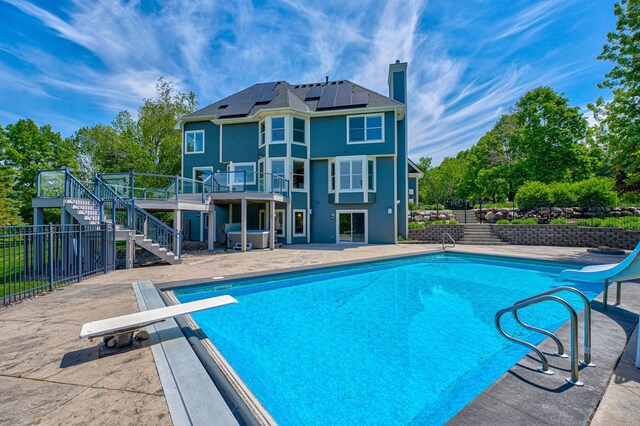 880 Norell Ave N, West Lakeland Twp, MN 55082 - view of pool featuring stairs, a water slide, a diving board, a wooden deck, and a patio