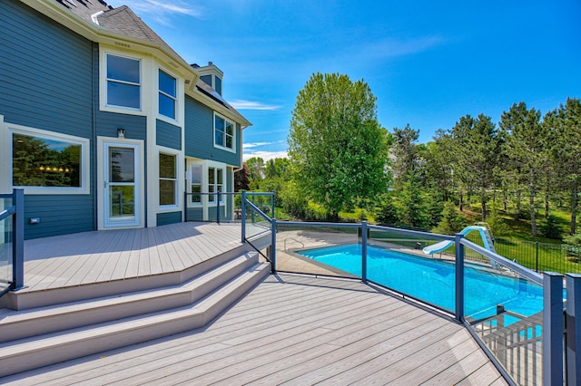 880 Norell Ave N, West Lakeland Twp, MN 55082 - view of swimming pool with a water slide, a deck, and view of wooded area