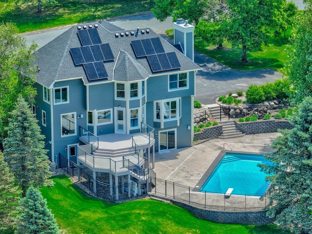 880 Norell Ave N, West Lakeland Twp, MN 55082 - rear view of house with stairway, roof mounted solar panels, a chimney, roof with shingles, and a patio area