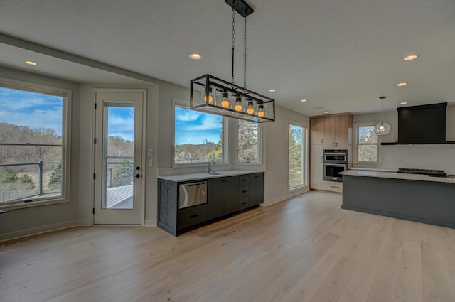 880 Norell Ave N, West Lakeland Twp, MN 55082 - kitchen featuring light countertops, light wood-style floors, extractor fan, recessed lighting, and a textured ceiling