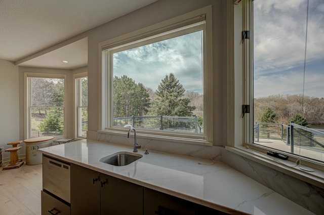 880 Norell Ave N, West Lakeland Twp, MN 55082 - kitchen with a sink, light stone countertops, and light wood-style floors