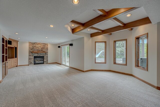 880 Norell Ave N, West Lakeland Twp, MN 55082 - unfurnished living room with light carpet, baseboards, a stone fireplace, recessed lighting, and beamed ceiling