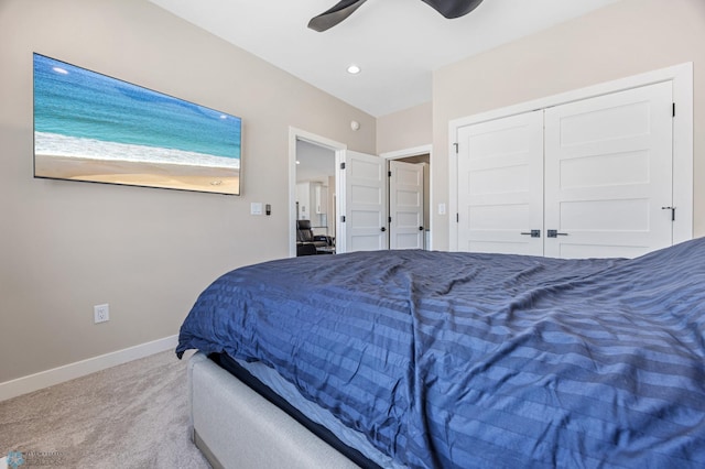 bedroom with recessed lighting, light colored carpet, a ceiling fan, baseboards, and a closet