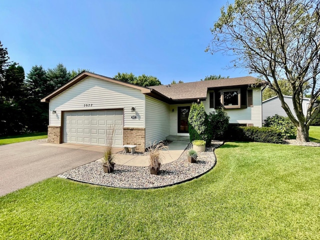 view of front of property featuring a garage and a front lawn