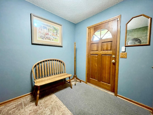 foyer entrance featuring a textured ceiling