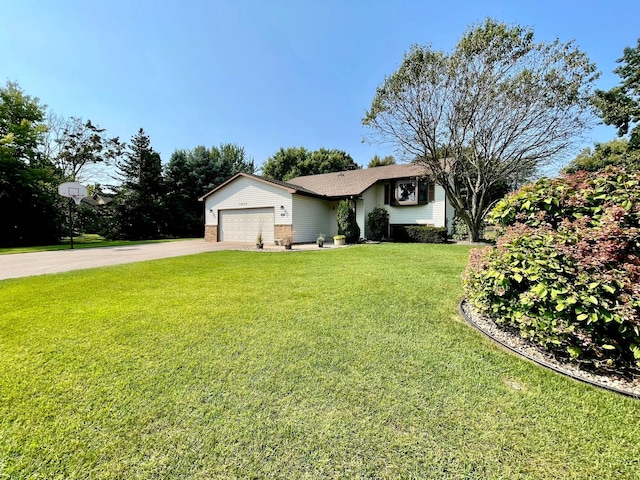 ranch-style home featuring a garage and a front lawn