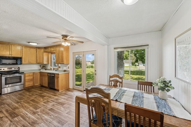 4345 Upper 145th St W, Rosemount, MN 55068 - kitchen with appliances with stainless steel finishes, light countertops, a textured ceiling, healthy amount of natural light, and dark wood finished floors