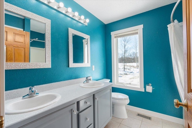 bathroom with vanity, a shower with curtain, toilet, and tile patterned floors