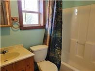 full bathroom with vanity, shower / bath combo, and toilet