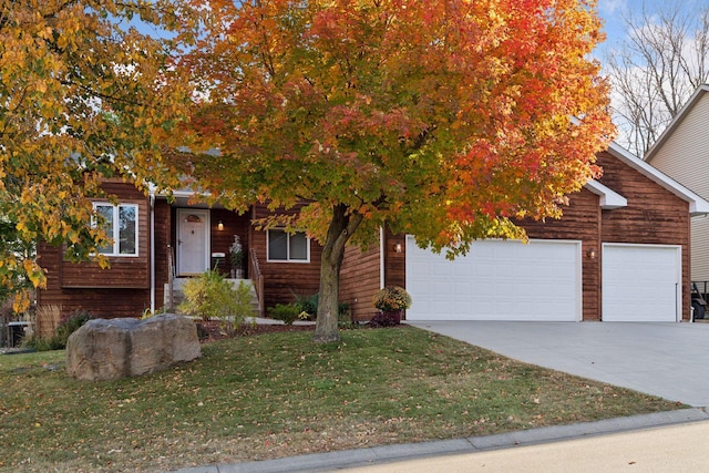 obstructed view of property featuring a garage and a front yard