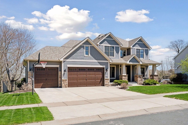 craftsman inspired home with an attached garage, a front lawn, stone siding, covered porch, and driveway