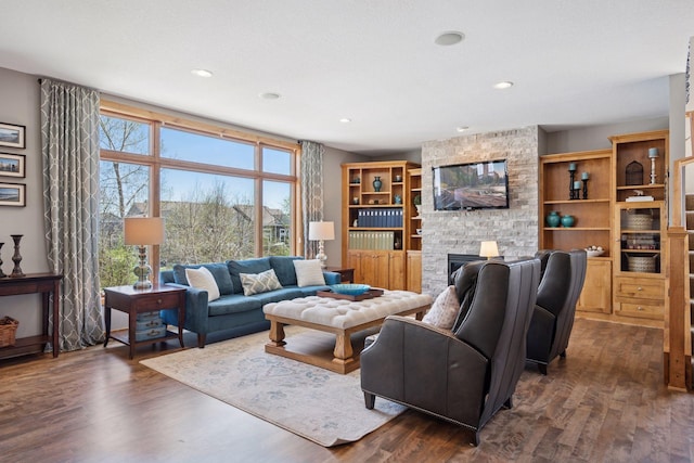 living area featuring recessed lighting, a fireplace, and dark wood finished floors