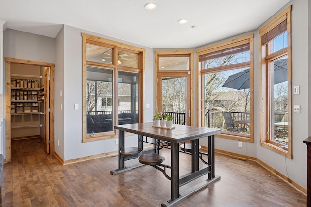 dining space with recessed lighting, baseboards, and wood finished floors