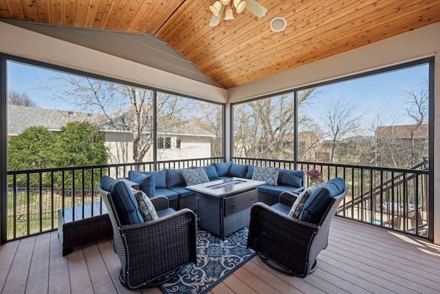 sunroom featuring plenty of natural light, outdoor lounge area, and a ceiling fan