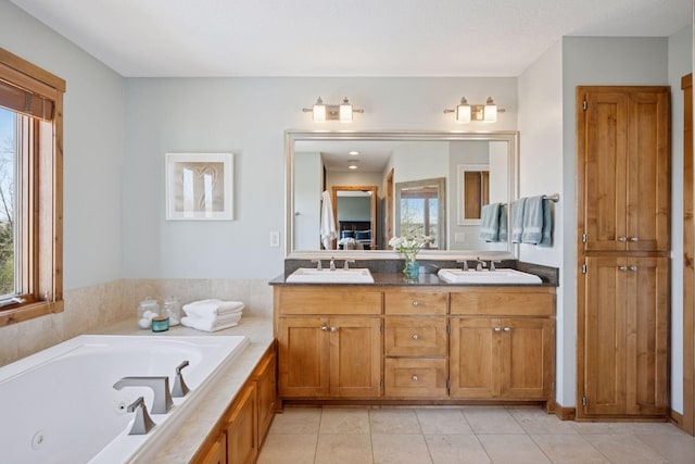bathroom featuring a whirlpool tub, a sink, tile patterned floors, and double vanity