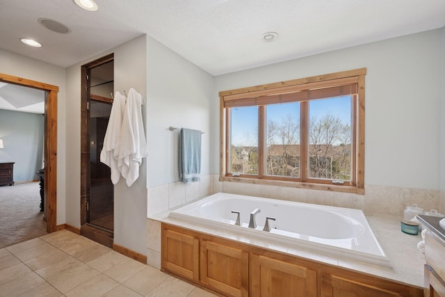 full bathroom with tile patterned floors, recessed lighting, and a bath