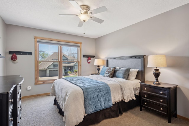 bedroom with baseboards, ceiling fan, and carpet