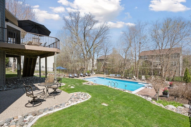 pool with a lawn, a patio area, and a deck