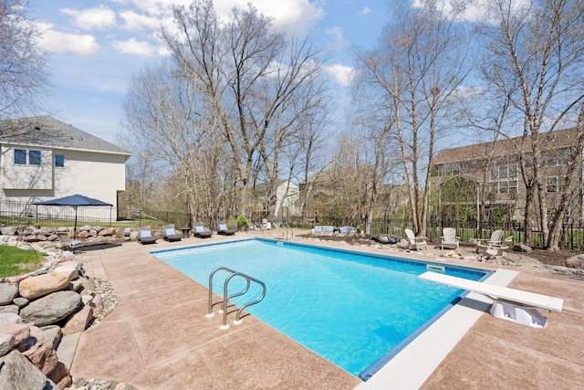 view of pool with a fenced in pool, fence, and a patio