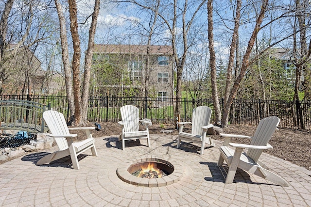 view of patio / terrace featuring a fire pit and fence