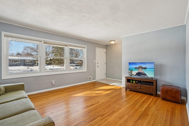 living room featuring ornamental molding and light hardwood / wood-style floors