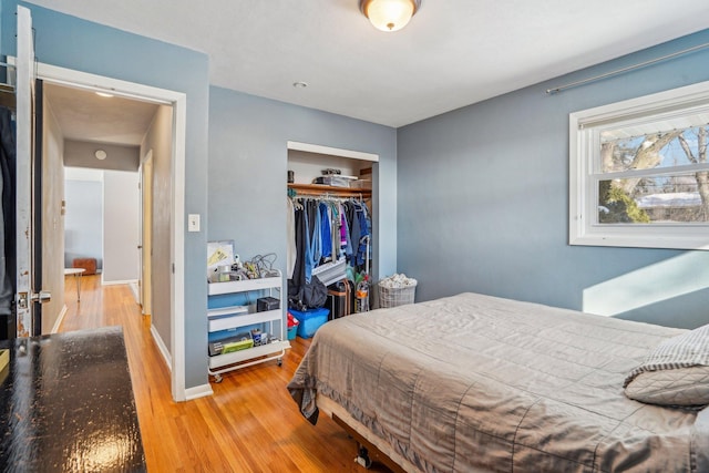 bedroom with hardwood / wood-style flooring and a closet