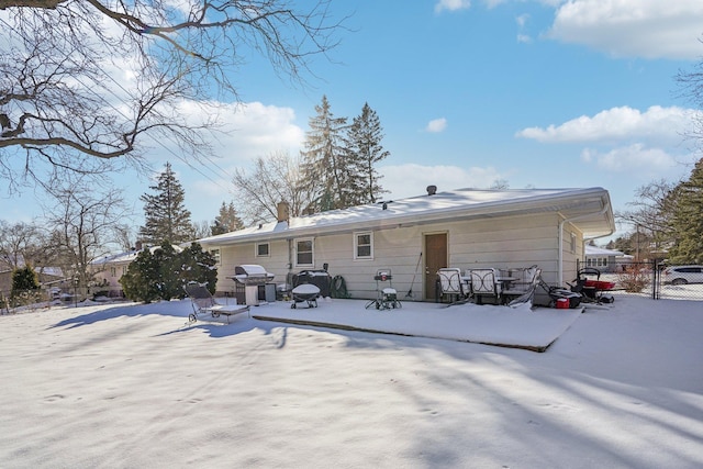 view of snow covered rear of property