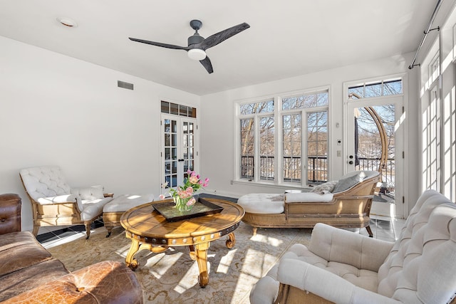 sitting room featuring french doors, visible vents, and ceiling fan