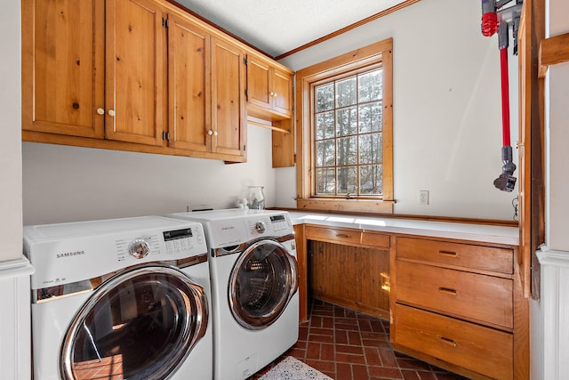 laundry room featuring brick floor, separate washer and dryer, and cabinet space