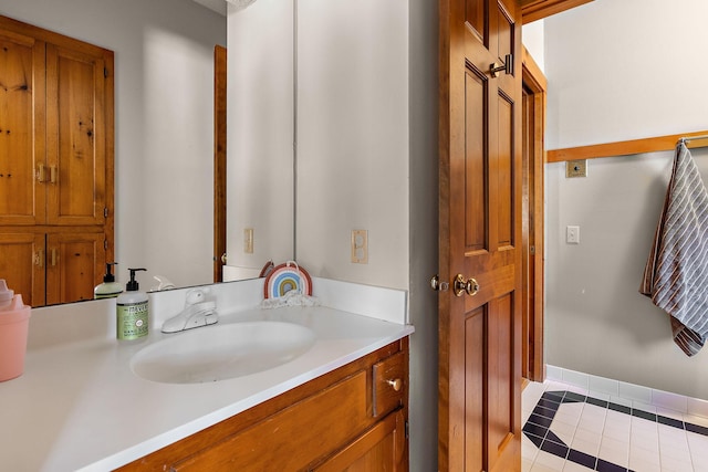 bathroom with tile patterned floors, baseboards, and vanity