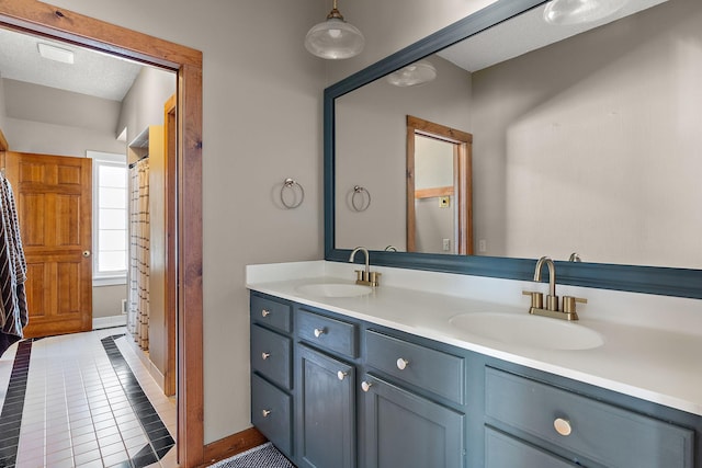 full bathroom featuring tile patterned floors, a sink, and double vanity