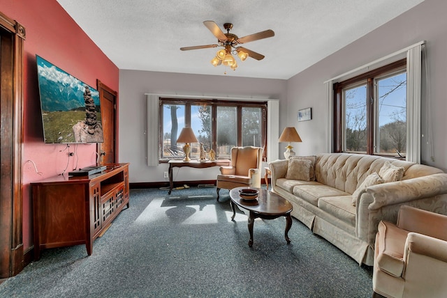 living room with a wealth of natural light, carpet floors, a textured ceiling, and a ceiling fan