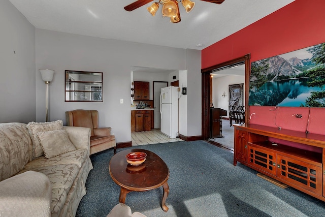 living room featuring baseboards, carpet floors, and ceiling fan