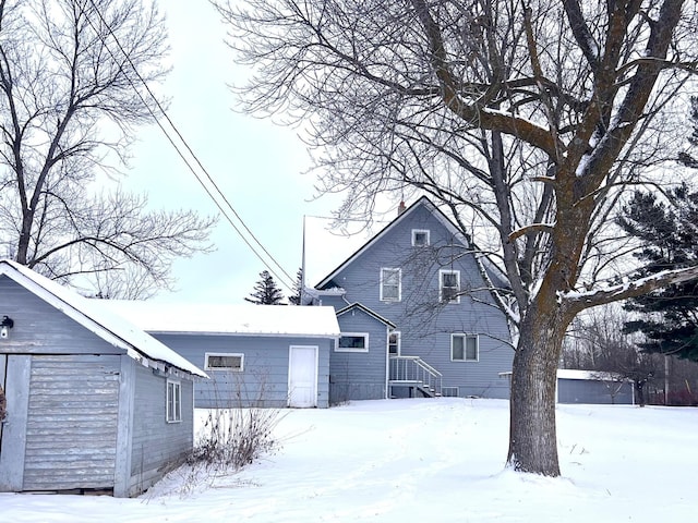 view of front of property featuring a garage and an outbuilding