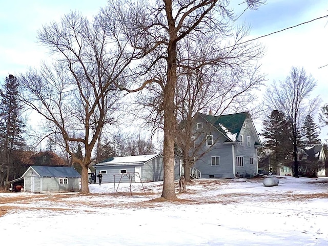 exterior space featuring a chimney, a detached garage, and an outdoor structure