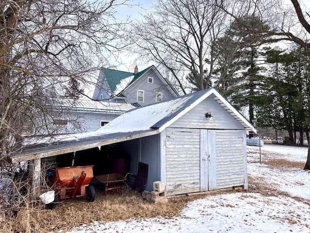 snow covered structure with an outdoor structure