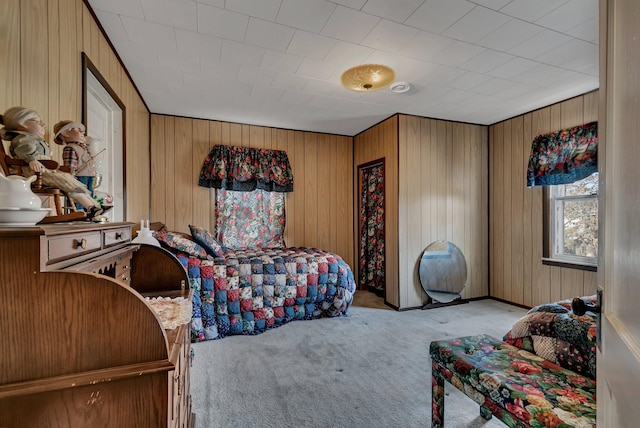 bedroom with carpet flooring and wooden walls