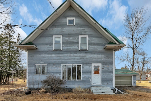 rear view of house with a garage