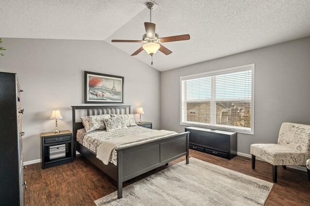 bedroom featuring baseboards, lofted ceiling, wood finished floors, a textured ceiling, and a ceiling fan