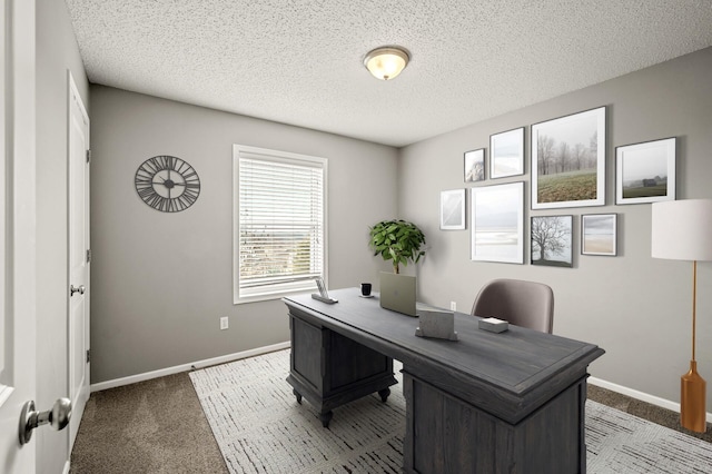 home office with carpet, baseboards, and a textured ceiling