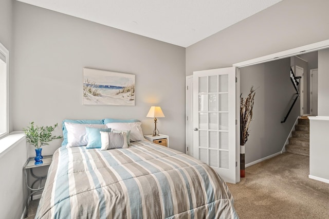 carpeted bedroom featuring baseboards