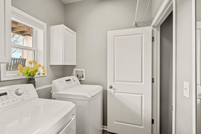 laundry room with cabinet space and washing machine and dryer