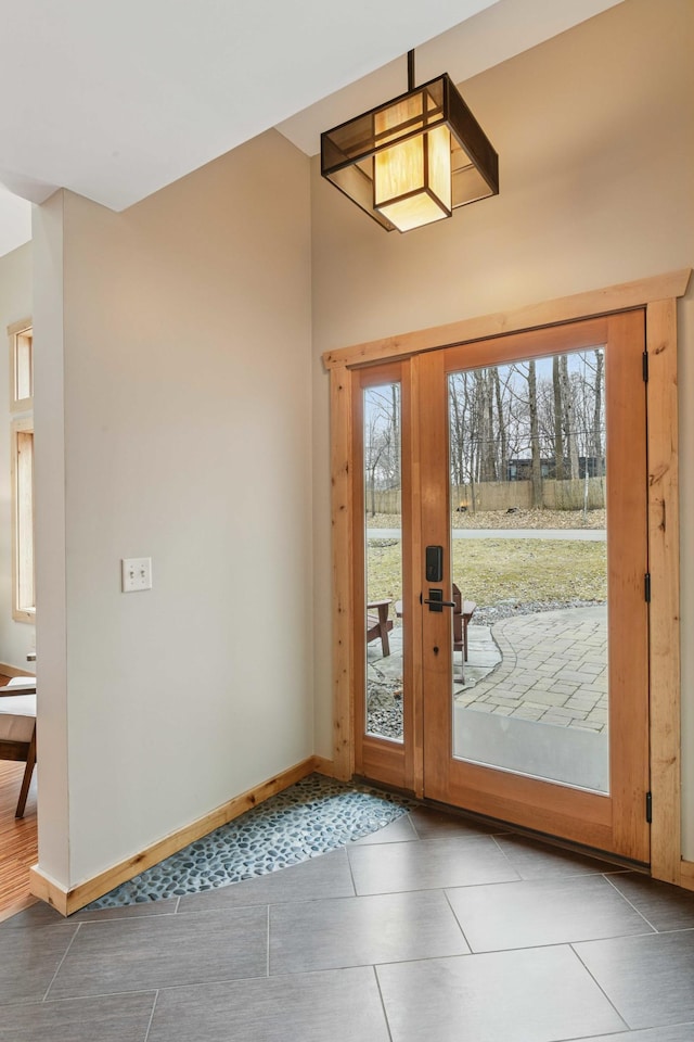 entryway with baseboards and tile patterned floors