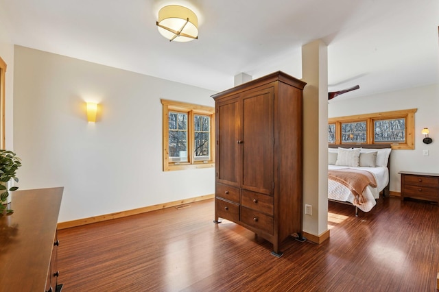 bedroom featuring dark wood-style floors, visible vents, and baseboards