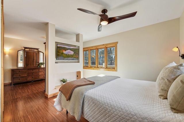 bedroom with ceiling fan, baseboards, and wood finished floors