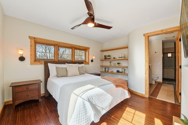 bedroom with ceiling fan, connected bathroom, baseboards, and wood finished floors